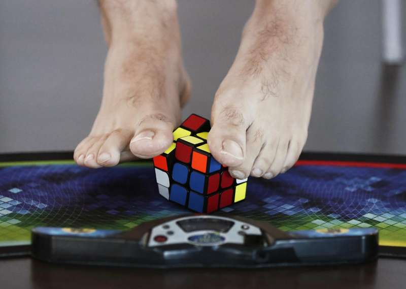Una persona completa un cubo de Rubik con los pies. EFE/JesÃºs Diges/Archivo